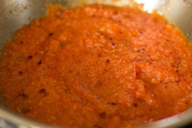 mixing tomato puree mixture in pan