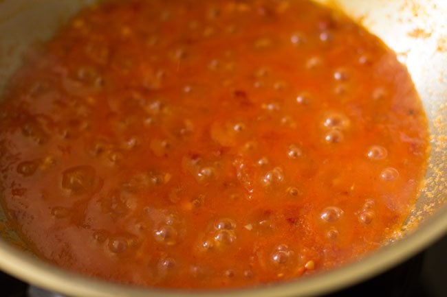 simmering the arrabiata sauce in the pan