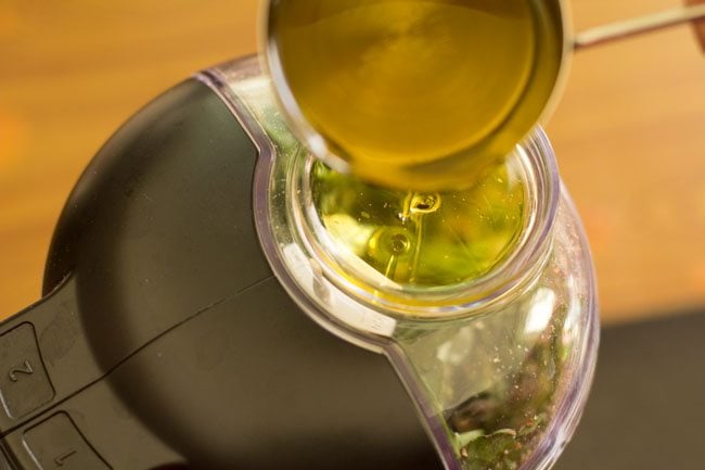 extra virgin olive oil being added in parts