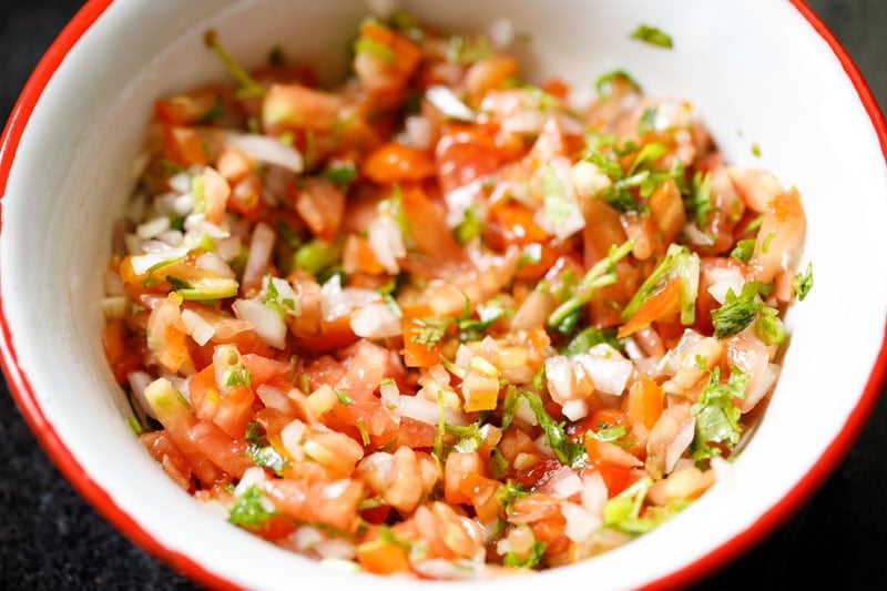 completed pico de gallo in a red rimmed bowl