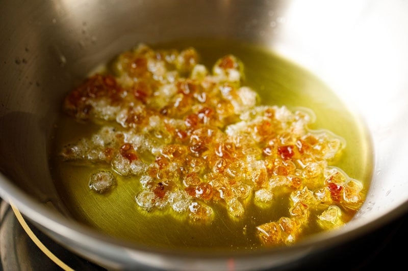 frying gond in hot ghee for pinni recipe. 