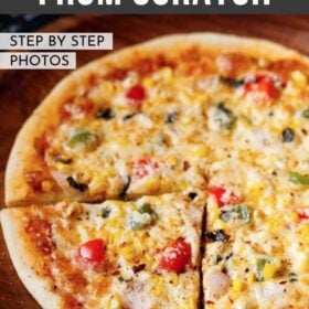 a triangular slice of veg pizza with the remaining pizza on a wooden pizza plate with a bold text of "Veg Pizza from Scratch" listed on top of image
