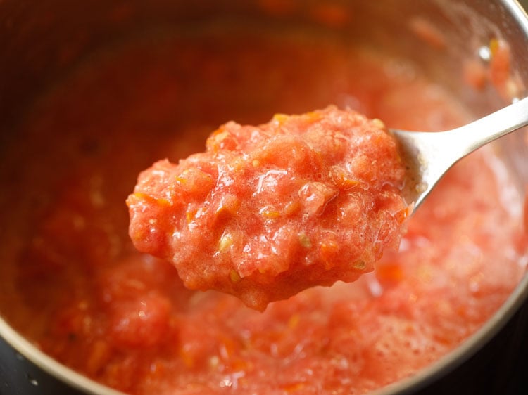 consistency of crushed tomatoes shown with a spoon