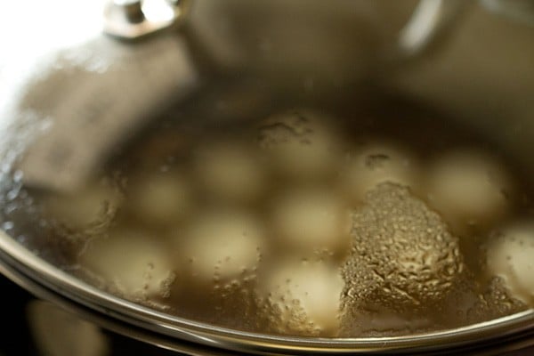 lid on pot with rasgulla in sugar syrup