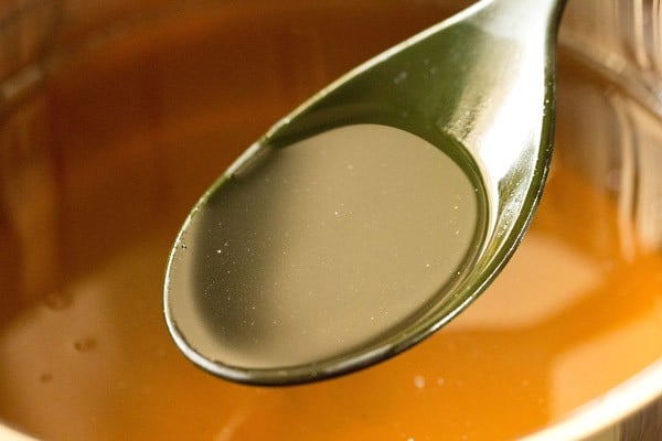 teaspoon showing syrup for rasgulla recipe