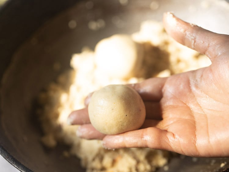 shaping a portion from the rava mixture into a laddu. 