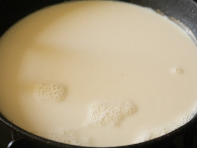 full fat milk added in a sauce pan for kheer recipe. 