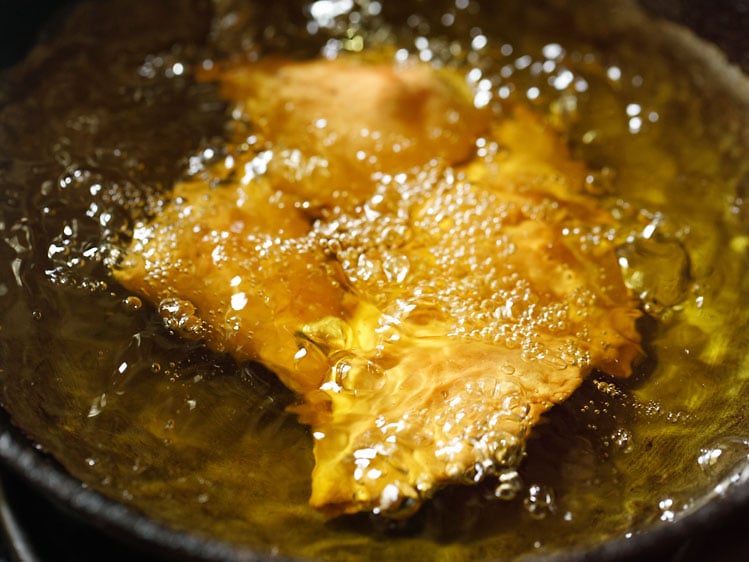 samosa turning crisp and golden in hot oil