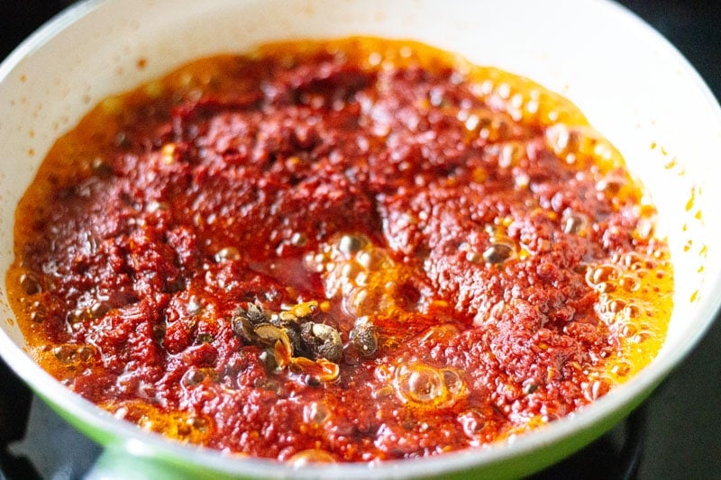 crushed sichuan pepper in red chilli paste in frying pan