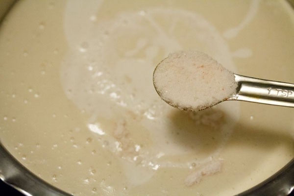 adding rock salt to batter in the pan