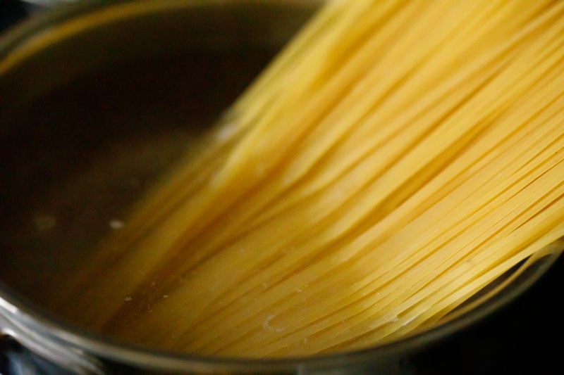spaghetti strands placed in hot boiling water