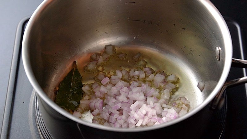 adding red onions to the pan