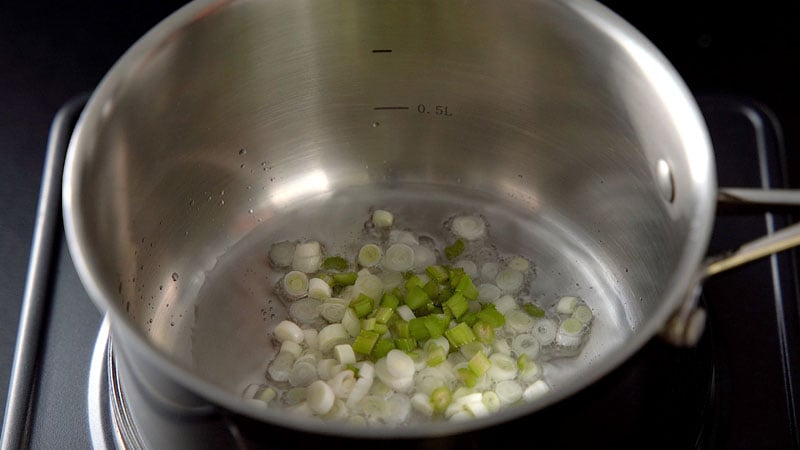 spring onion whites and celery in oil in a sauce pan