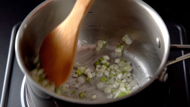 spring onion whites and celery being sauteed