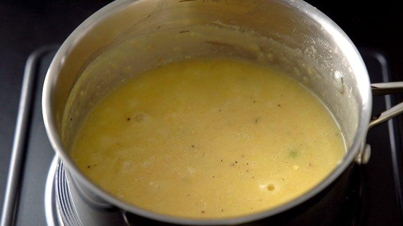 simmering sweet corn soup in pan