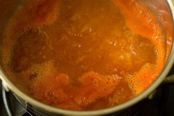 tomato broth simmering in pan