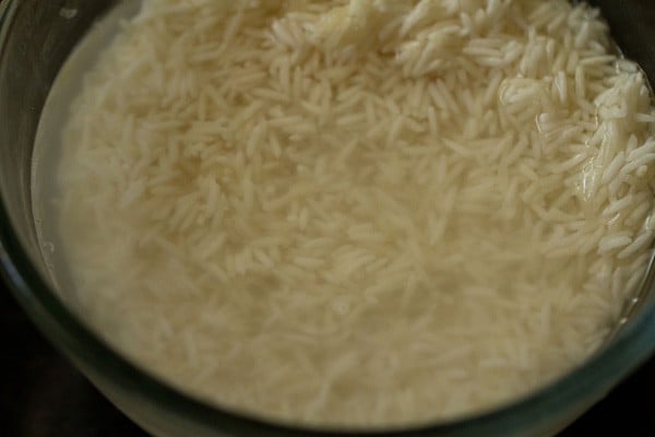 rice being soaked in water for tomato rice recipe