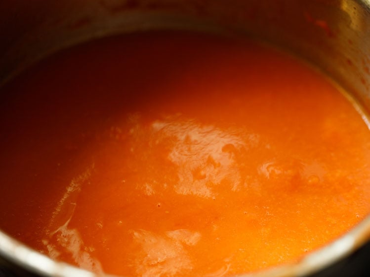 smooth tomato soup base added in the steel pan