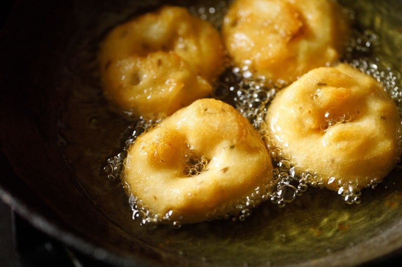 vada getting fried in oil are becoming more golden