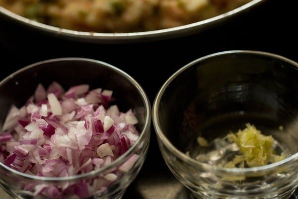 chopped onions and green chili, garlic, ginger paste in glass bowls