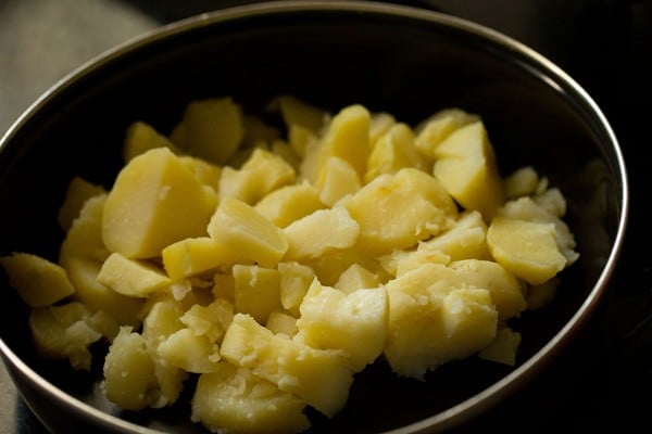 boiled chopped potatoes in a black bowl