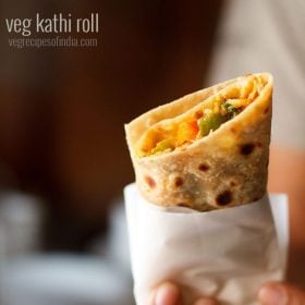 vegetarian kathi roll in a hand with text layover.